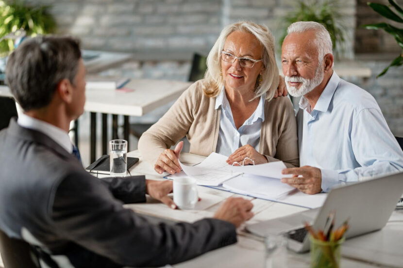 elderly couple meeting with a financial advisor